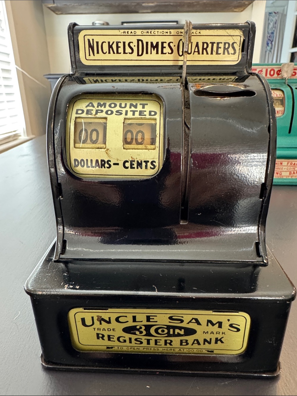 Vintage black uncle Sam’s three coin, mechanical register savings bank